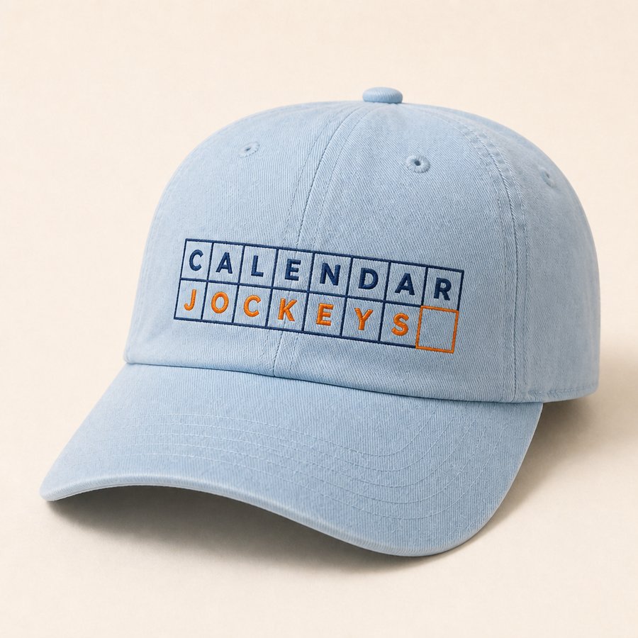 Washed blue dad cap with the grid wordmark embroidered in navy and orange